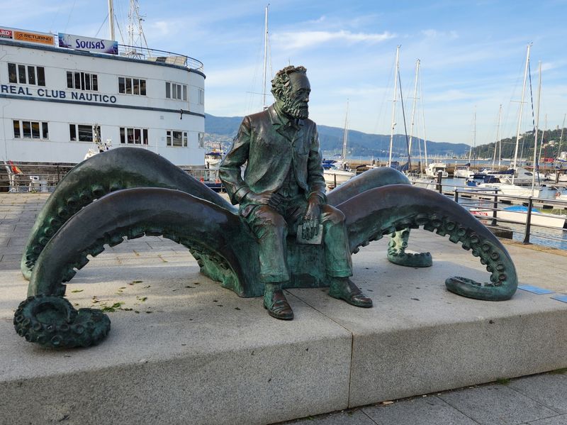 Bronze statue of author Jules Verne seated on a giant squid, located at the Vigo harbor in Spain; symbolizes imagination, exploration, and literary legacy.