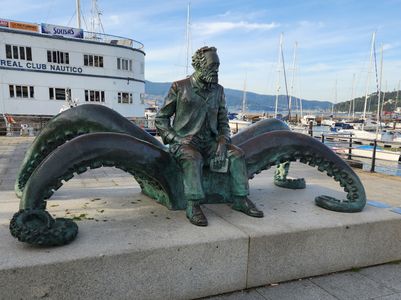 Bronze statue of author Jules Verne seated on a giant squid, located at the Vigo harbor in Spain; symbolizes imagination, exploration, and literary legacy.
